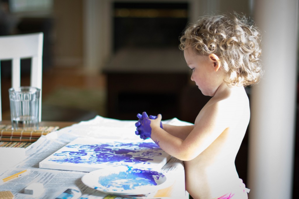 Emma wanted to paint canvas for daddy with handprints. We're going to add another color Of course, we had to start with purple. It's her favorite.