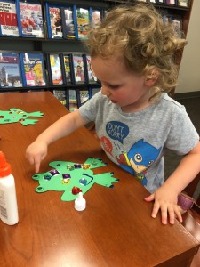 Emma decorating her frog; she was so excited we had purple glitter glue. (Just in case she's never told you, purple is her favorite color. Liam's frog is in the background. He did great when he wasn't trying to swallow the jewels.)