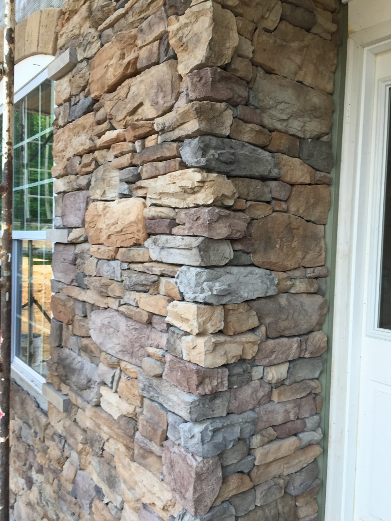 A close-up of the stone on the outside...it's a bit darker than the stone I like on the house I used as the basis for what I want our house to look like. I like the red in it though, and I think it dulls down the green. I can't wait to see it with the shutters!