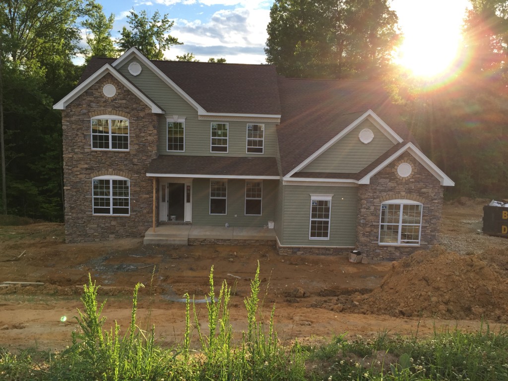 Drove by our house tonight. Drywall is done. Cabinets and railings were ready to go for tomorrow. I'm still trying to decide if I like my color choices. I think I need to see the shutters on it.